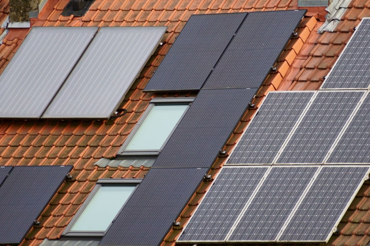 Mastering the First Impression: Your intriguing post title goes here Close-up of solar panels on a tiled roof, showcasing sustainable energy solutions.