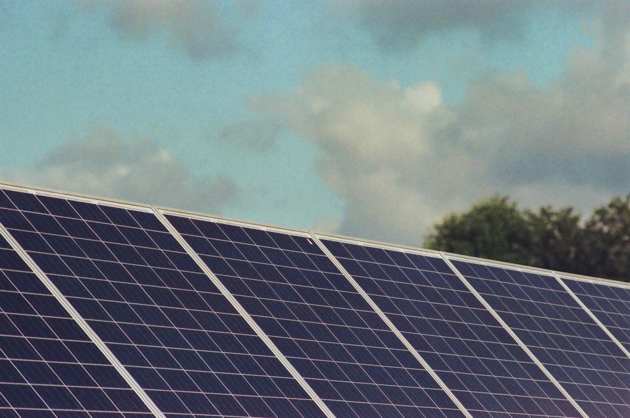 service-03 Photograph of solar panels capturing renewable energy under a blue sky, promoting sustainability and environmental protection.